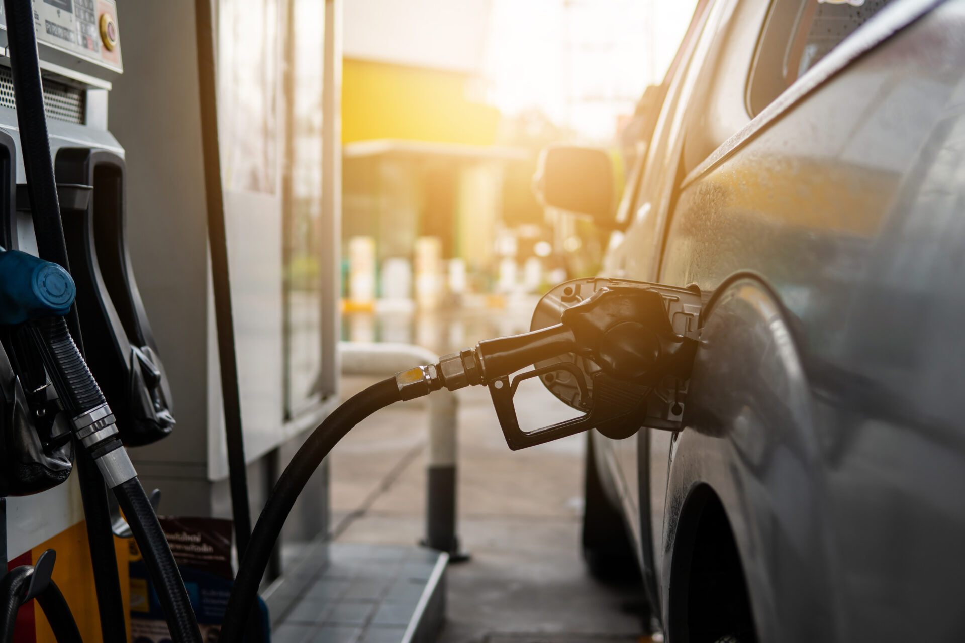 Fuel nozzle to refill fuel in car at gas station.
