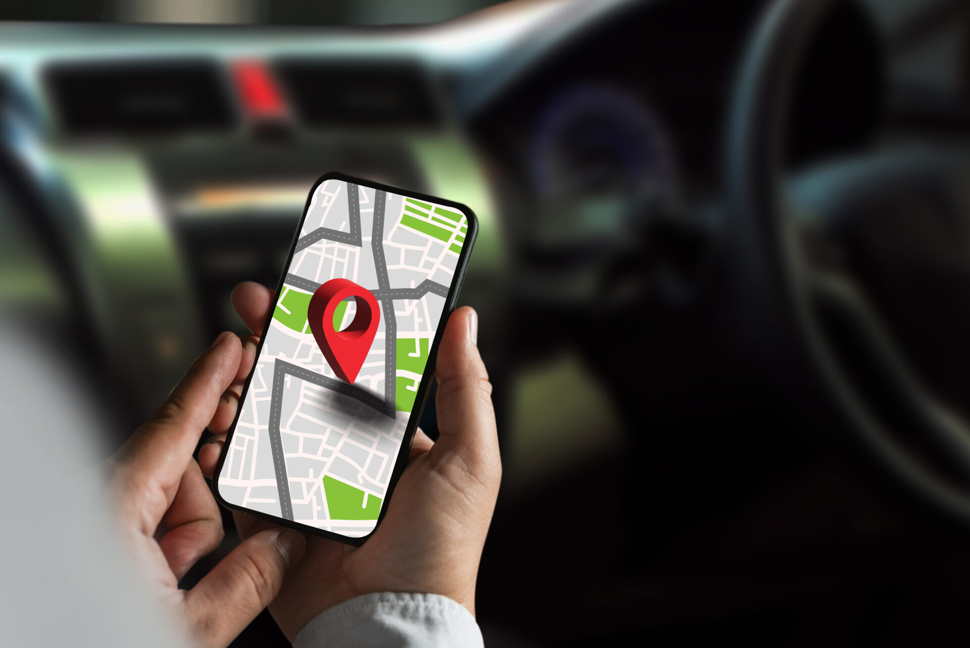 gps map ,man using a smartphone displaying a map in a car gps navigation system