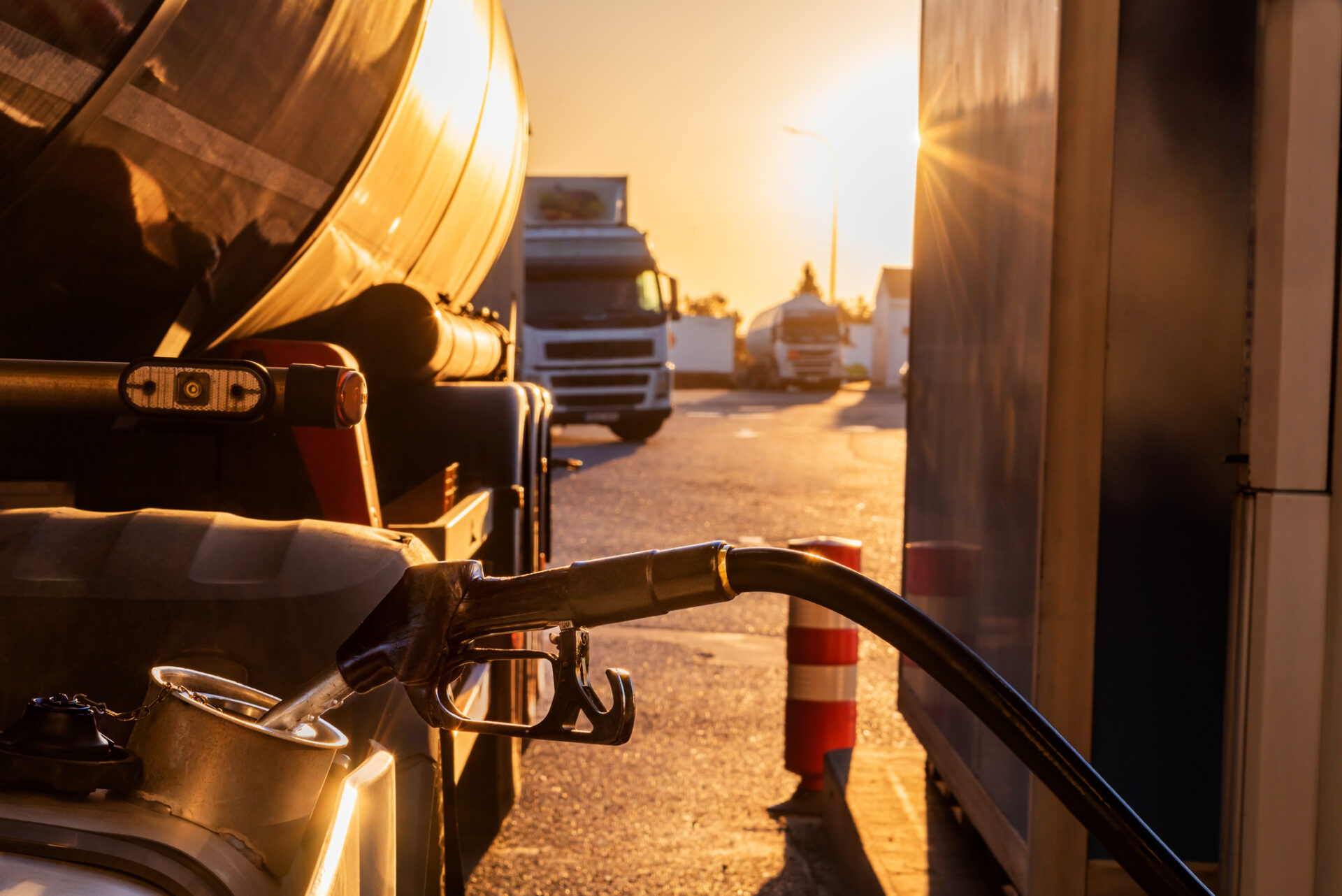 Filling the fuel tank of a truck at a gas station.