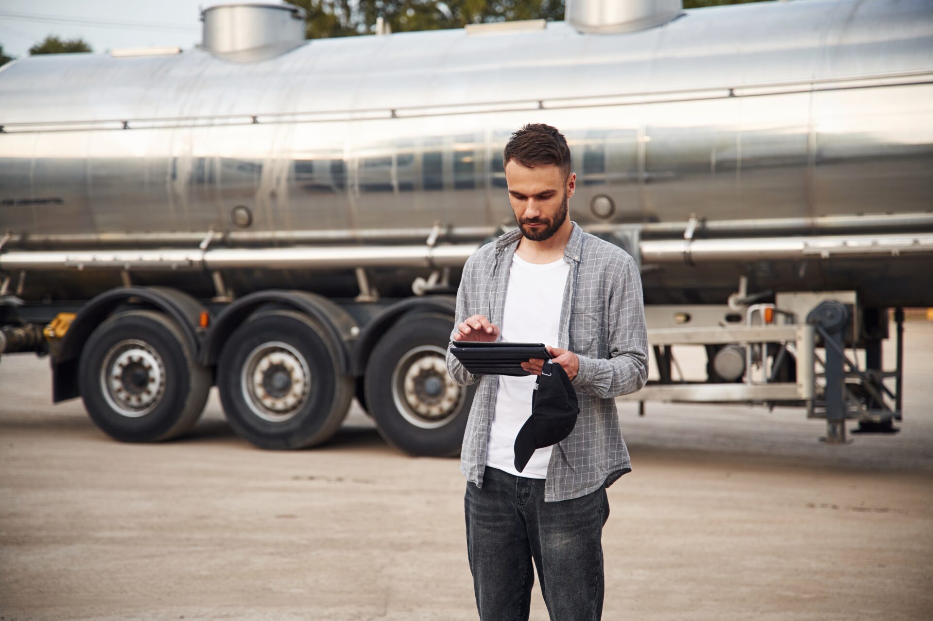 Handsome and young truck driver in casual clothes.