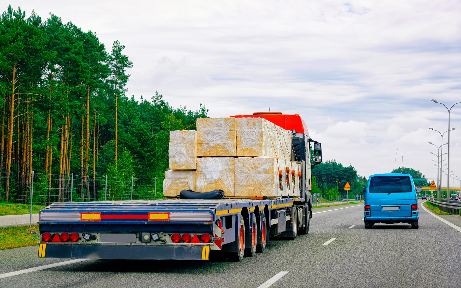 Truck in summer road of Slovenia. Trucker in highway. Lorry doing logistics work. Semi trailer with driver. Big cargo car drive. Freight delivery. Transport export industry. Container with goods